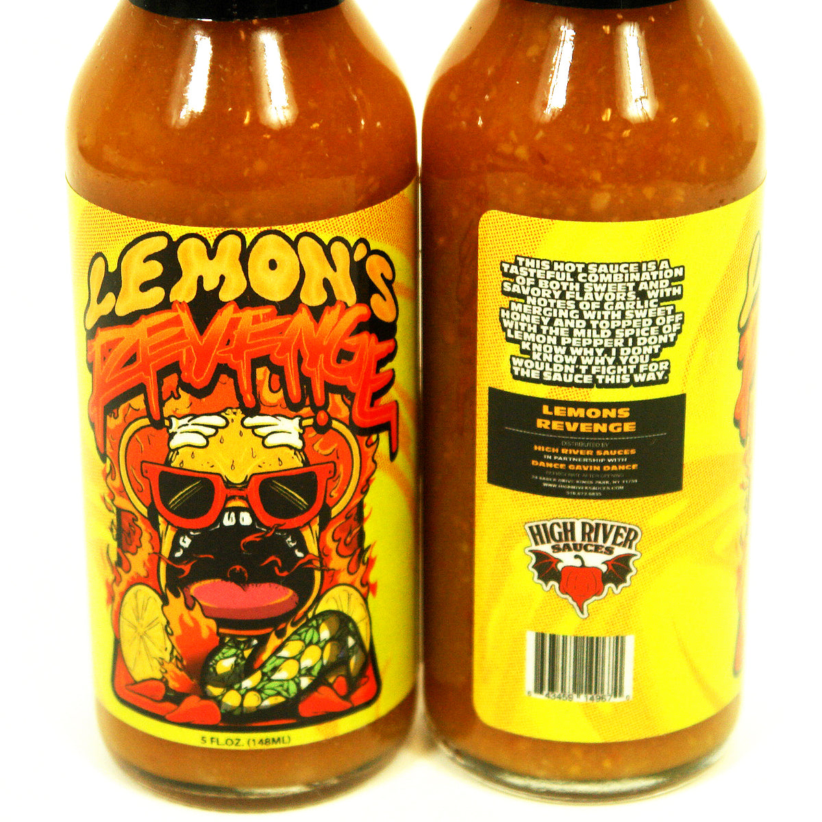 image of a hot sauce bottle on a white background. hot sauce says label says lemon's revenge with a lemon wearing sunglasses surrounded by fire. side view of the label's description