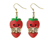 Strawberry skeleton earrings on a white background