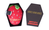 A novelty plush strawberry toy with a knife handle attached, shown next to its black coffin-shaped packaging box on a white background.