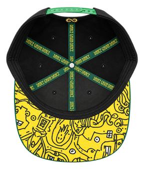 Top-down view of a black snapback cap with a bright yellow brim featuring black doodle-style graphics, green trim, and a green hanging strap. The interior has green and black straps printed repeatedly with the brand name 'DANCE GAVIN DANCE'.
