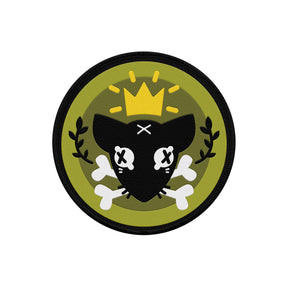 circle patch mock up on white background. black rim of circle with dead black rat with black x's as eyes and white bones in mouth wearing a gold crown framed with black laurels and a two tone green backgound.